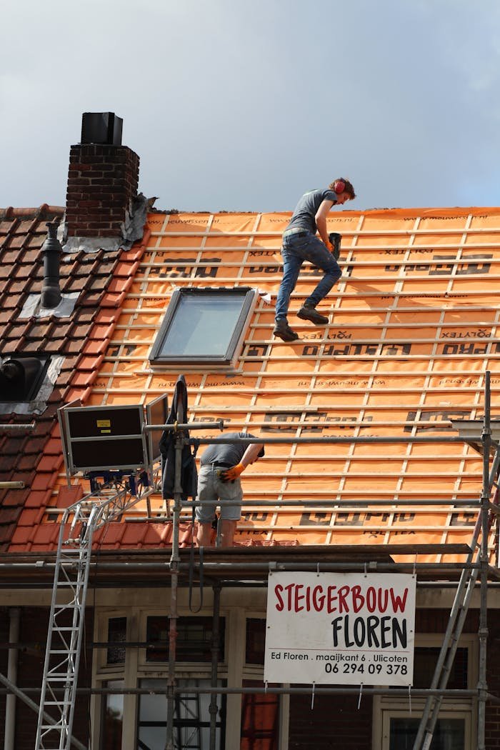 gallery-02 Construction workers installing new roof tiles in the Netherlands.